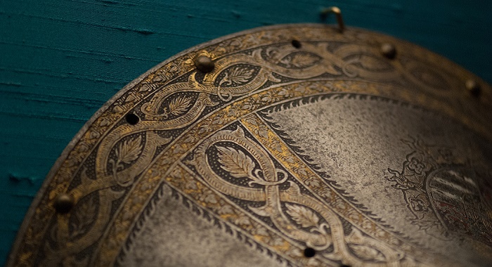 Photo of a decorative shield and the detail on it 